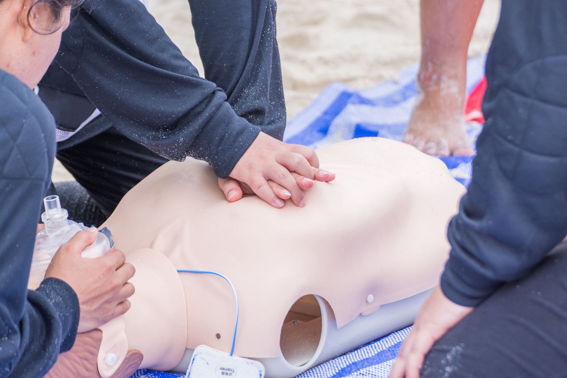 cpr training in dummy victim drowning on the beach